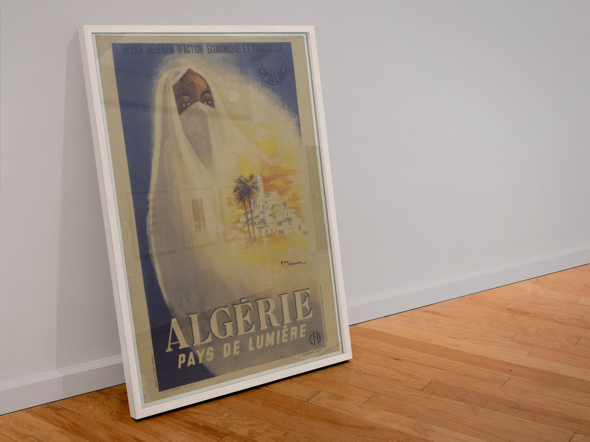 Algerie Pays de Lumiere poster in a white frame leaning against a wall