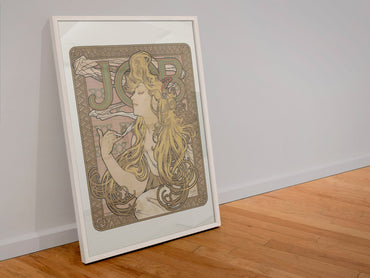 Alphonse Mucha JOB cigarette paper poster in a white frame leaning against a wall
