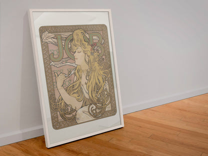 Alphonse Mucha JOB cigarette paper poster in a white frame leaning against a wall