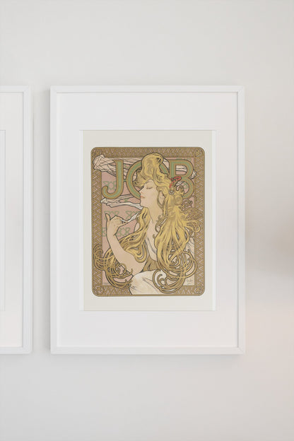 Alphonse Mucha JOB cigarette paper poster in a white frame on a light wall