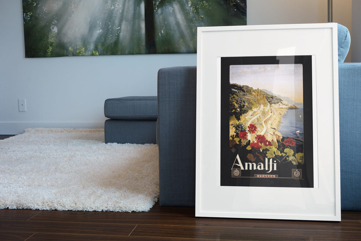 Amalfi Italy poster leaning beside a blue sofa