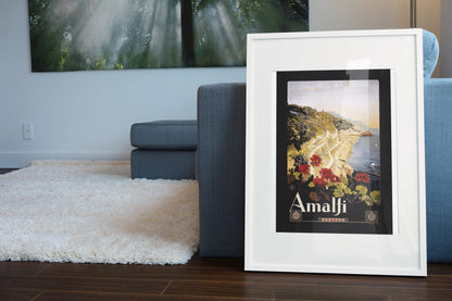 Amalfi Italy poster leaning beside a blue sofa