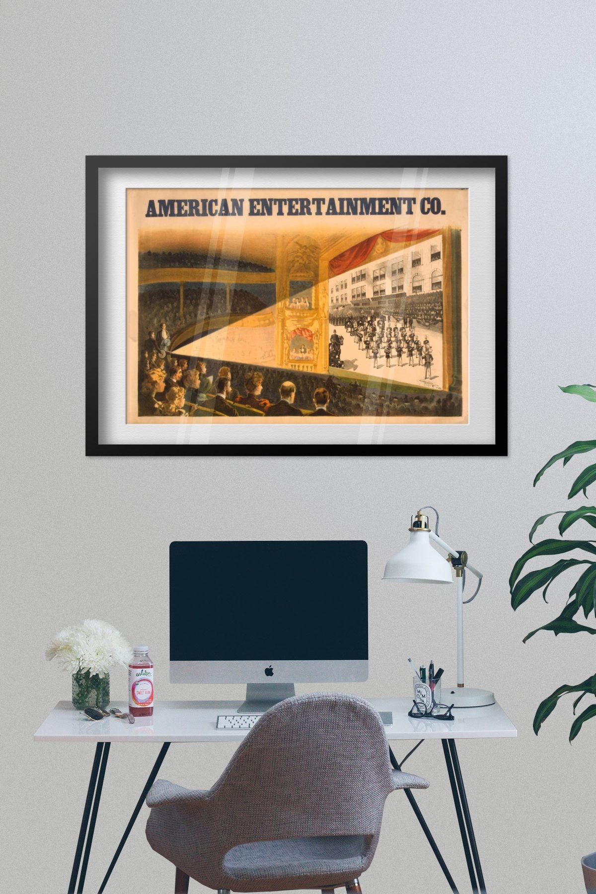 American Entertainment Co Moving Pictures poster framed on a grey wall above a desk