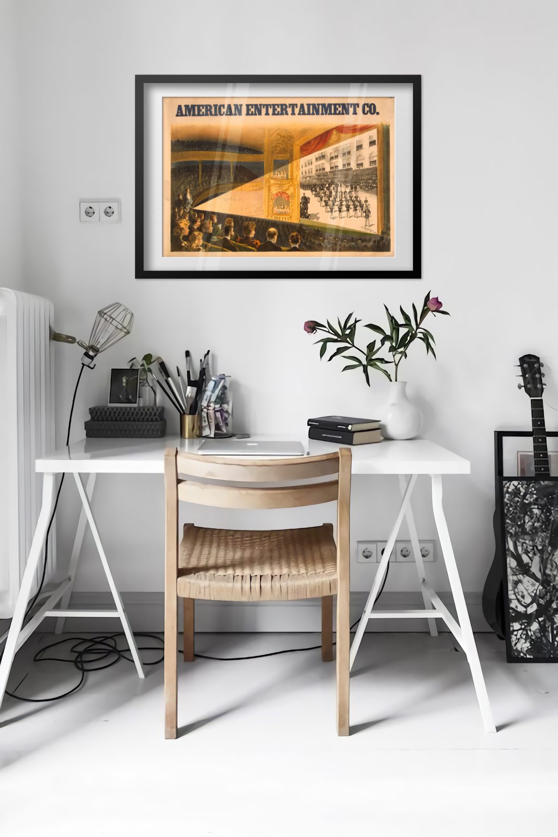 American Entertainment Co Moving Pictures poster framed above a desk in a bright white room