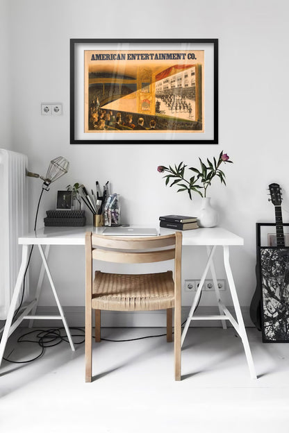 American Entertainment Co Moving Pictures poster framed above a desk in a bright white room