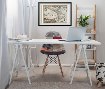 Americas and Pacific 1609 Map framed above a white desk in a home office