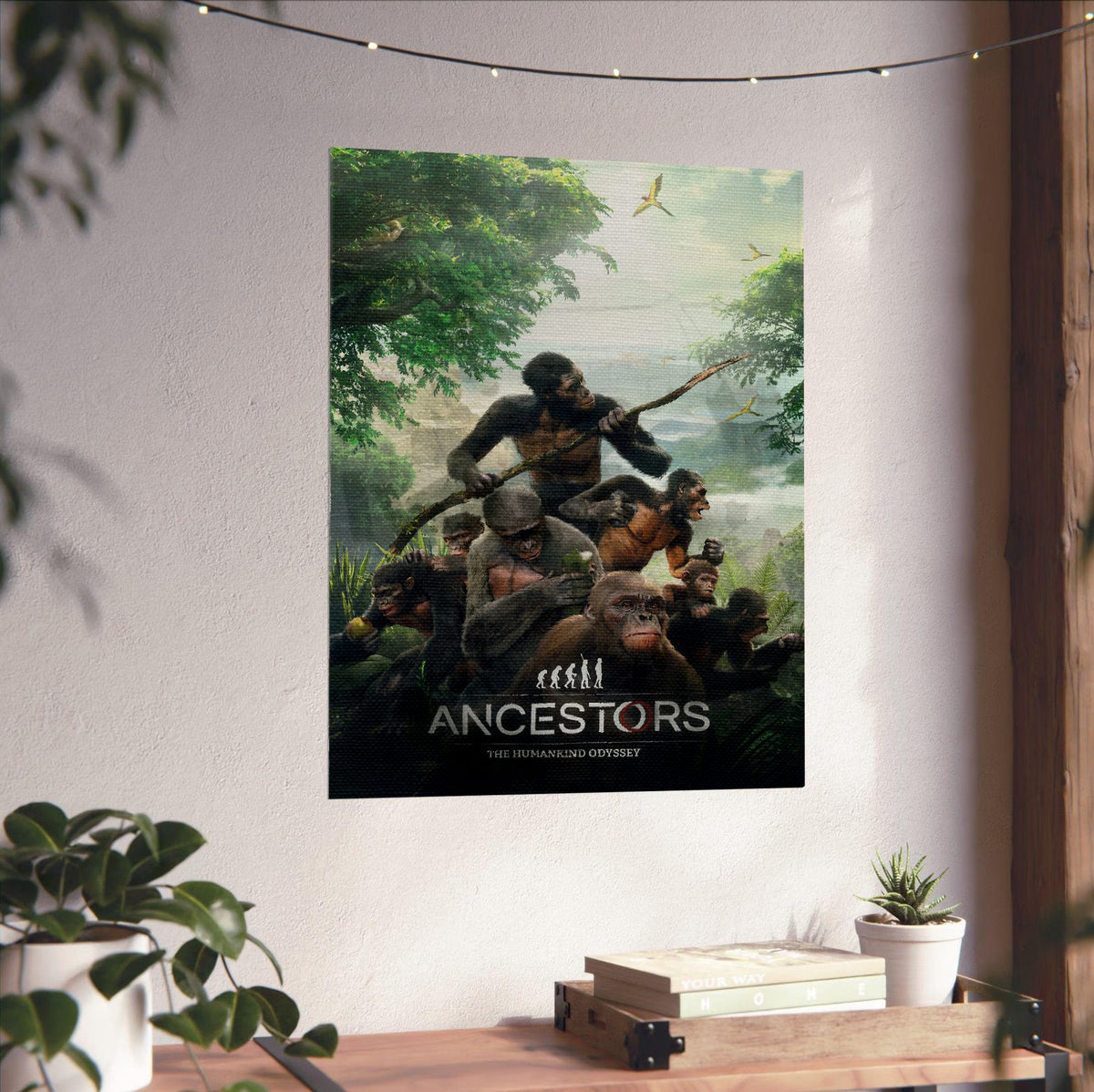 Ancestors: The Humankind Odyssey Key Art poster unframed on a white wall above a desk