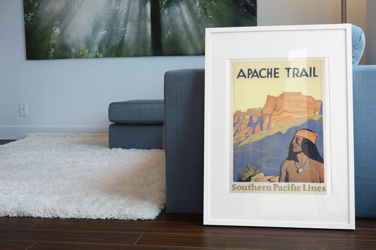 Apache Trail Southern Pacific poster leaning beside a blue sofa