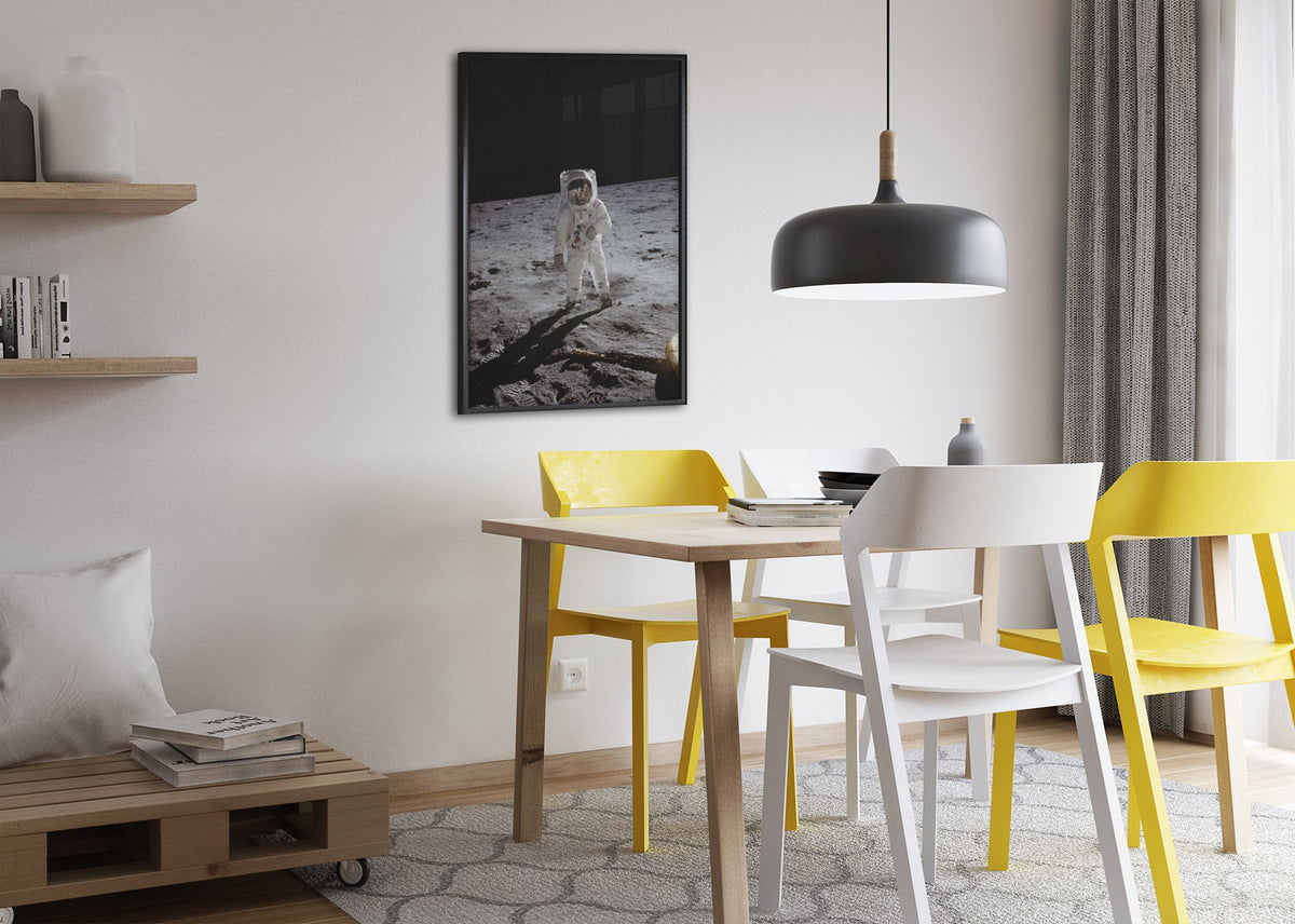 Apollo 11 Buzz Aldrin moonwalk poster framed above a dining table