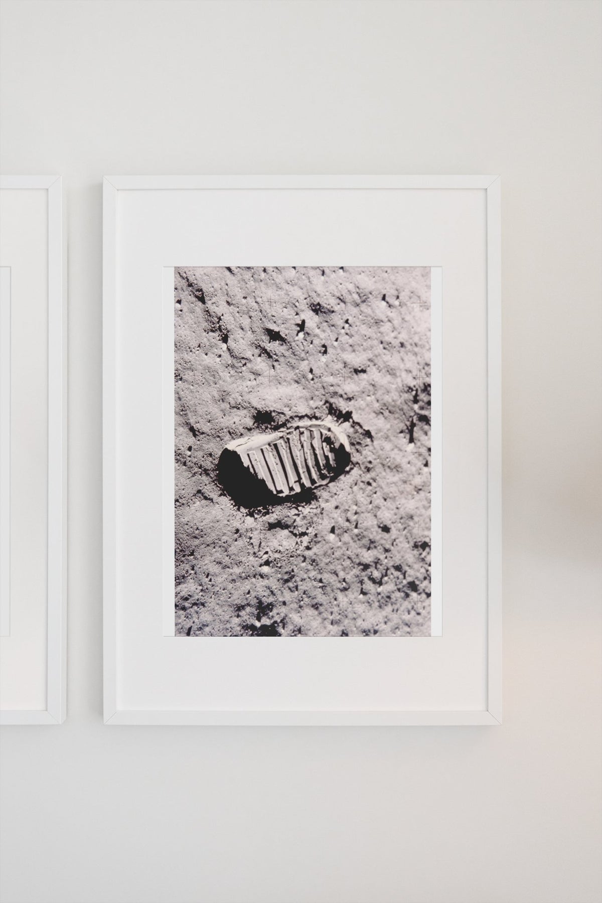 Apollo 11 bootprint on the Moon poster in a white frame on a light wall