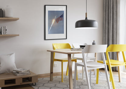 Apollo 11 rocket launch with the US flag poster framed above a dining table