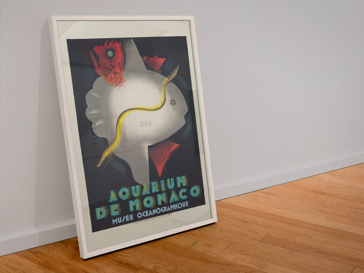 Aquarium de Monaco poster in a white frame leaning against a wall