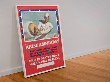 Arise Americans Join the Navy poster in a white frame leaning against a wall