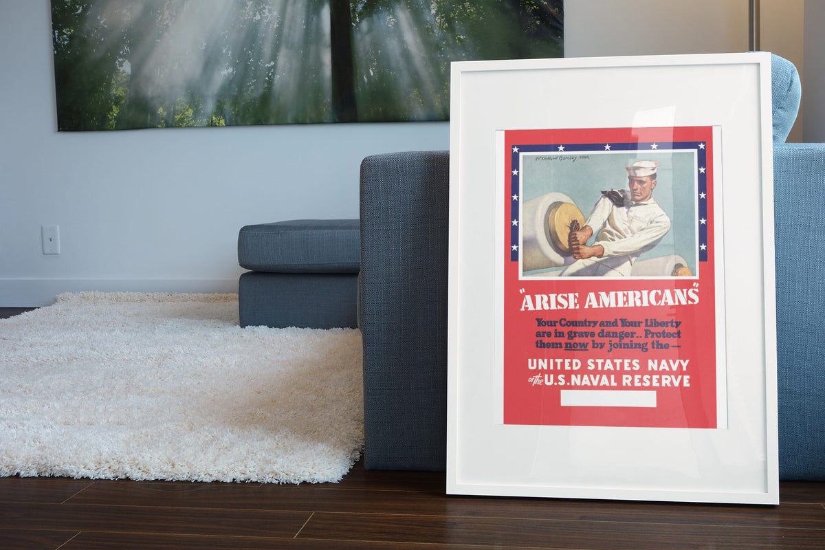 Arise Americans Join the Navy poster leaning beside a blue sofa