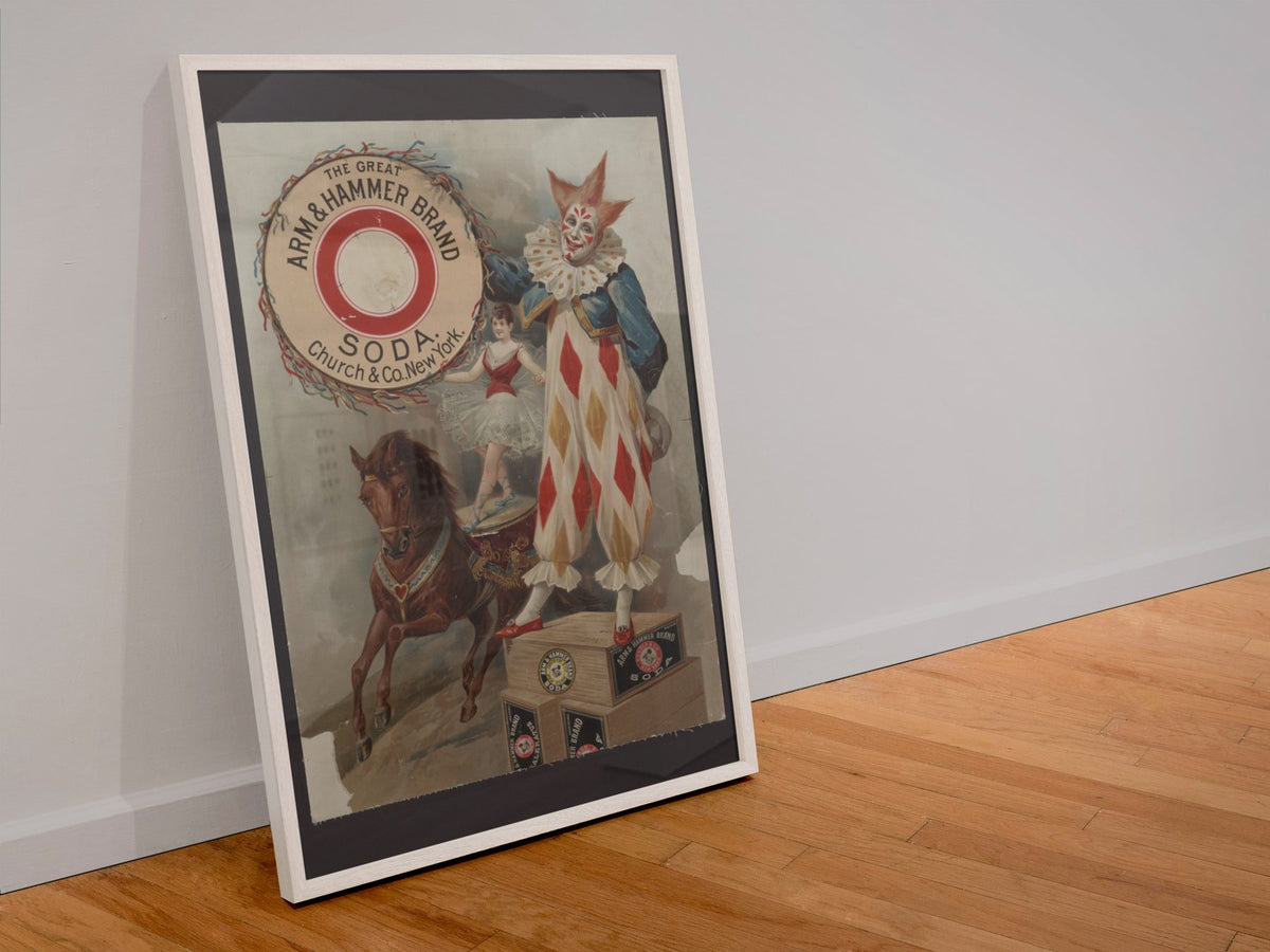 Arm and Hammer Soda Clown poster in a white frame leaning against a wall