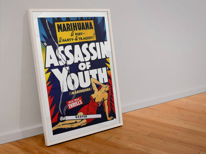 Assassin of Youth poster in a white frame leaning against a wall