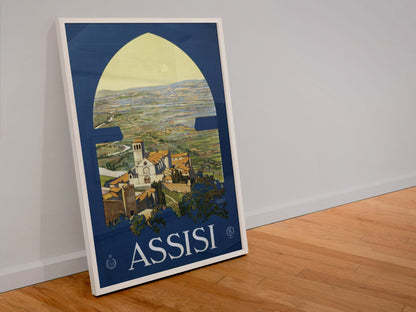 Assisi poster in a white frame leaning against a wall