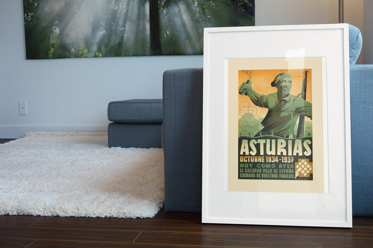 Asturias 1934-1937 poster leaning beside a blue sofa