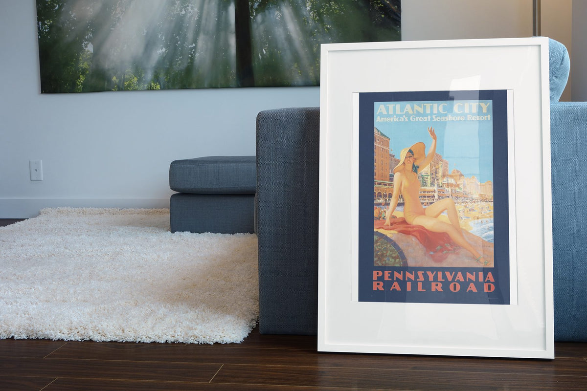 Atlantic City Pennsylvania Railroad poster leaning beside a blue sofa
