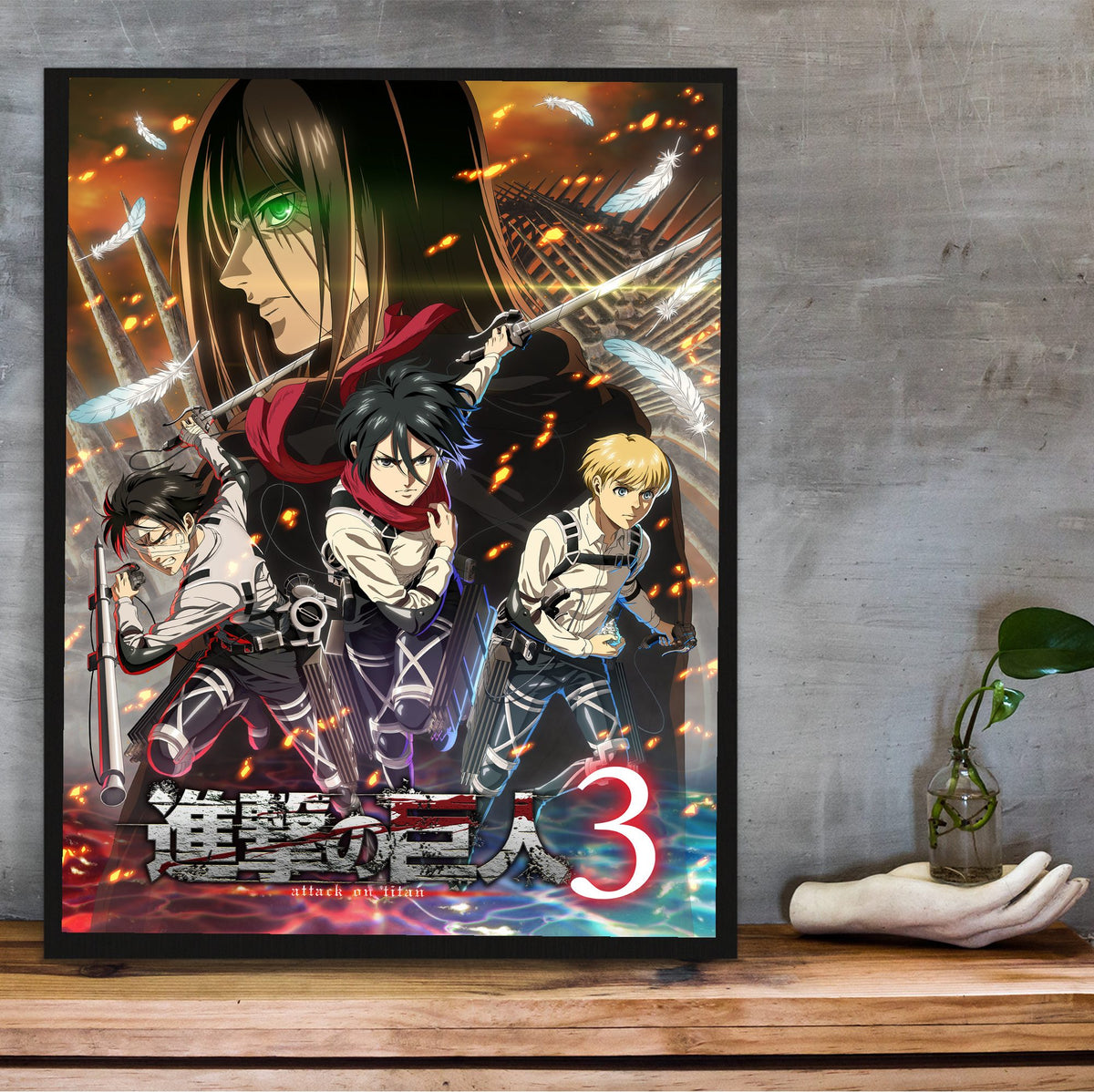 Attack on Titan Season 3 Key Visual Art poster in a black frame on a wooden shelf against concrete