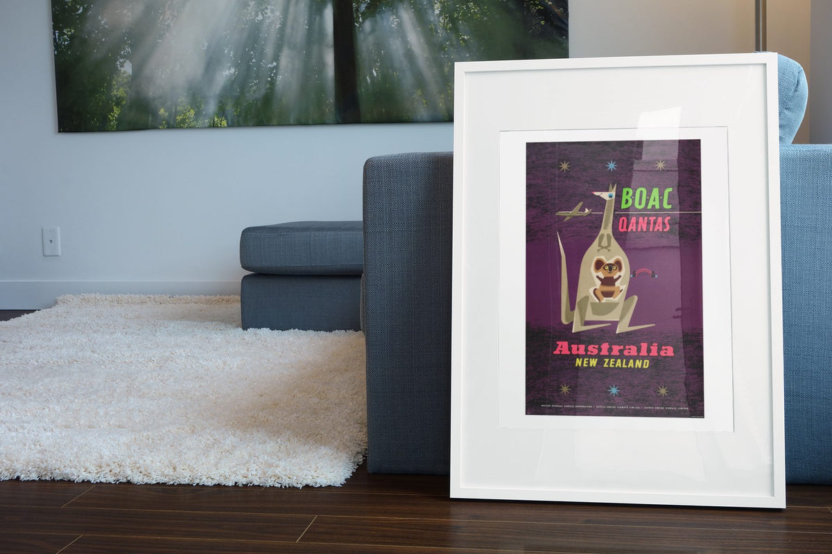 Australia New Zealand BOAC Qantas poster leaning beside a blue sofa