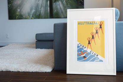Australia Surf Club poster leaning beside a blue sofa