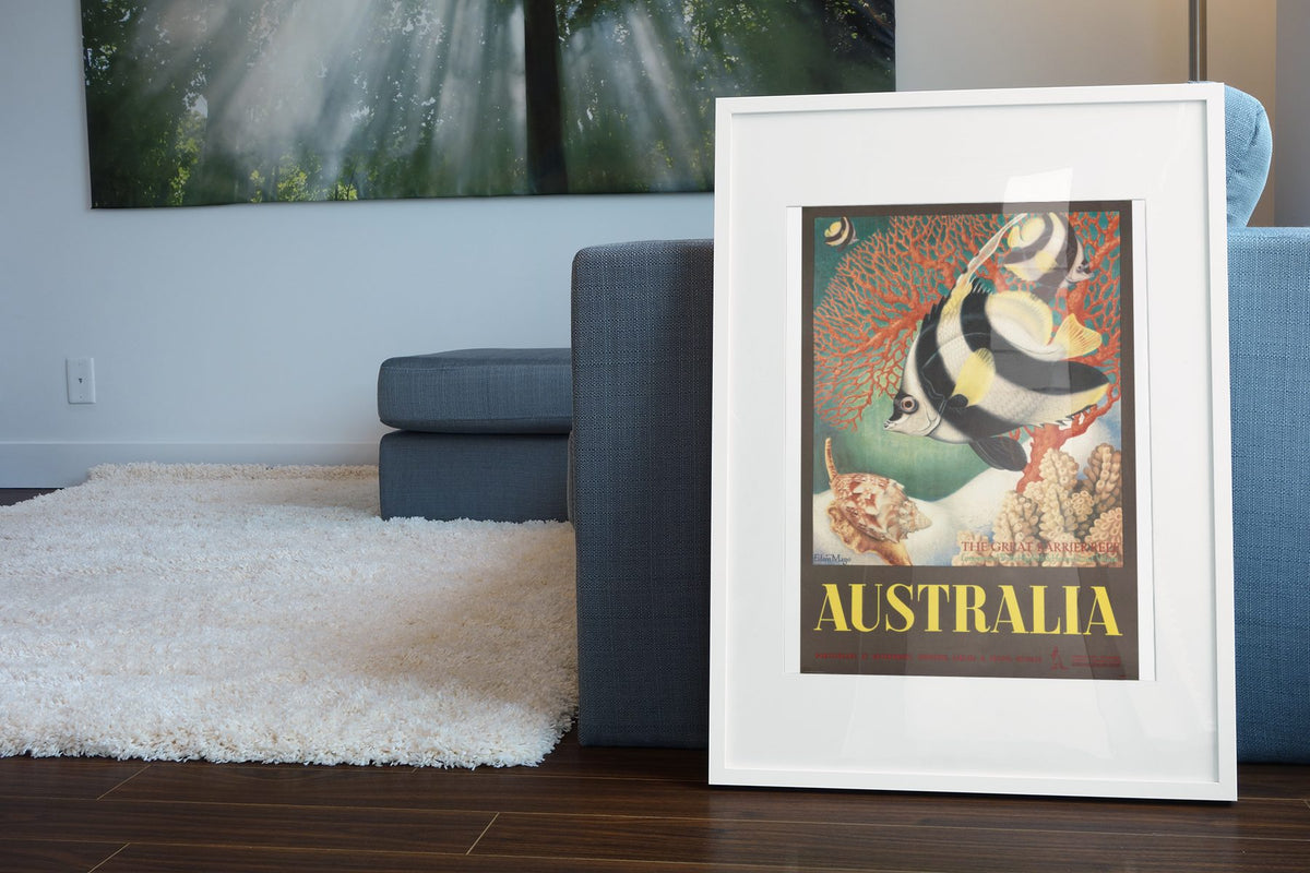 Australia Great Barrier Reef poster leaning beside a blue sofa