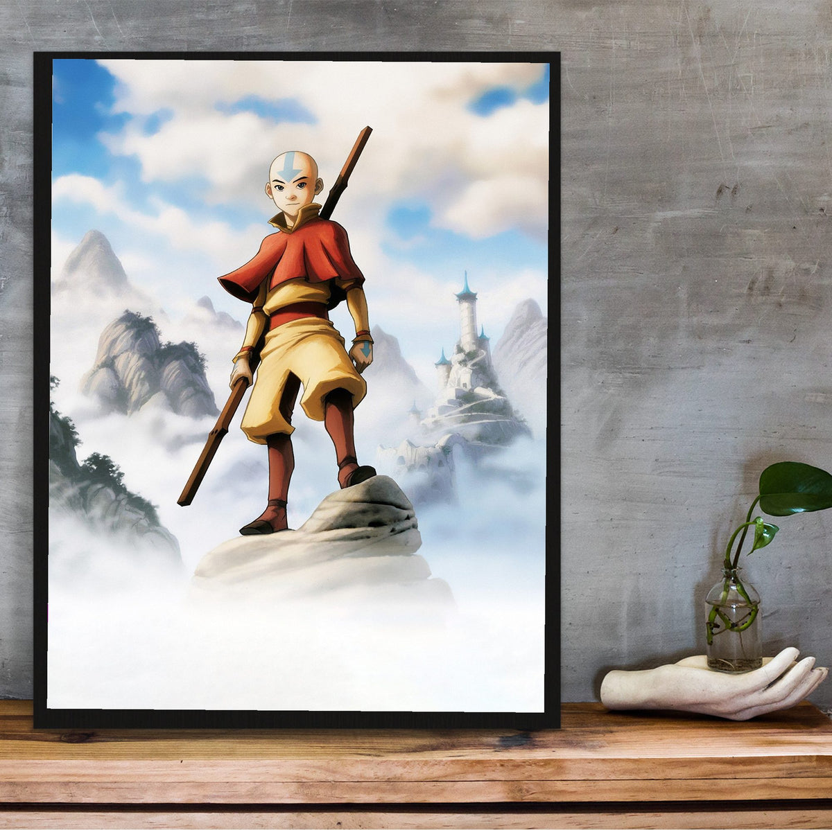 Avatar: The Last Airbender Aang Art poster in a black frame on a wooden shelf against concrete