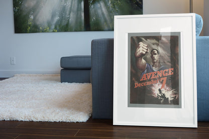 Avenge December 7 poster leaning beside a blue sofa