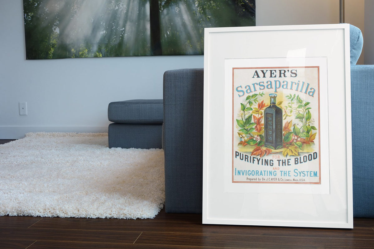 Ayers Sarsaparilla poster leaning beside a blue sofa