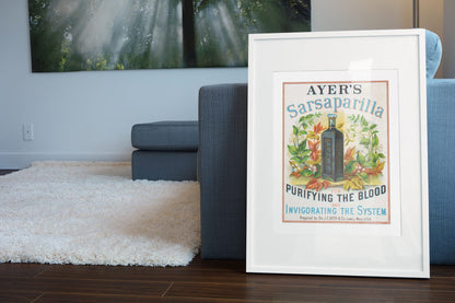 Ayers Sarsaparilla poster leaning beside a blue sofa