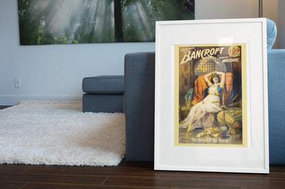 Frederick Bancroft Slave of the Orient poster leaning beside a blue sofa
