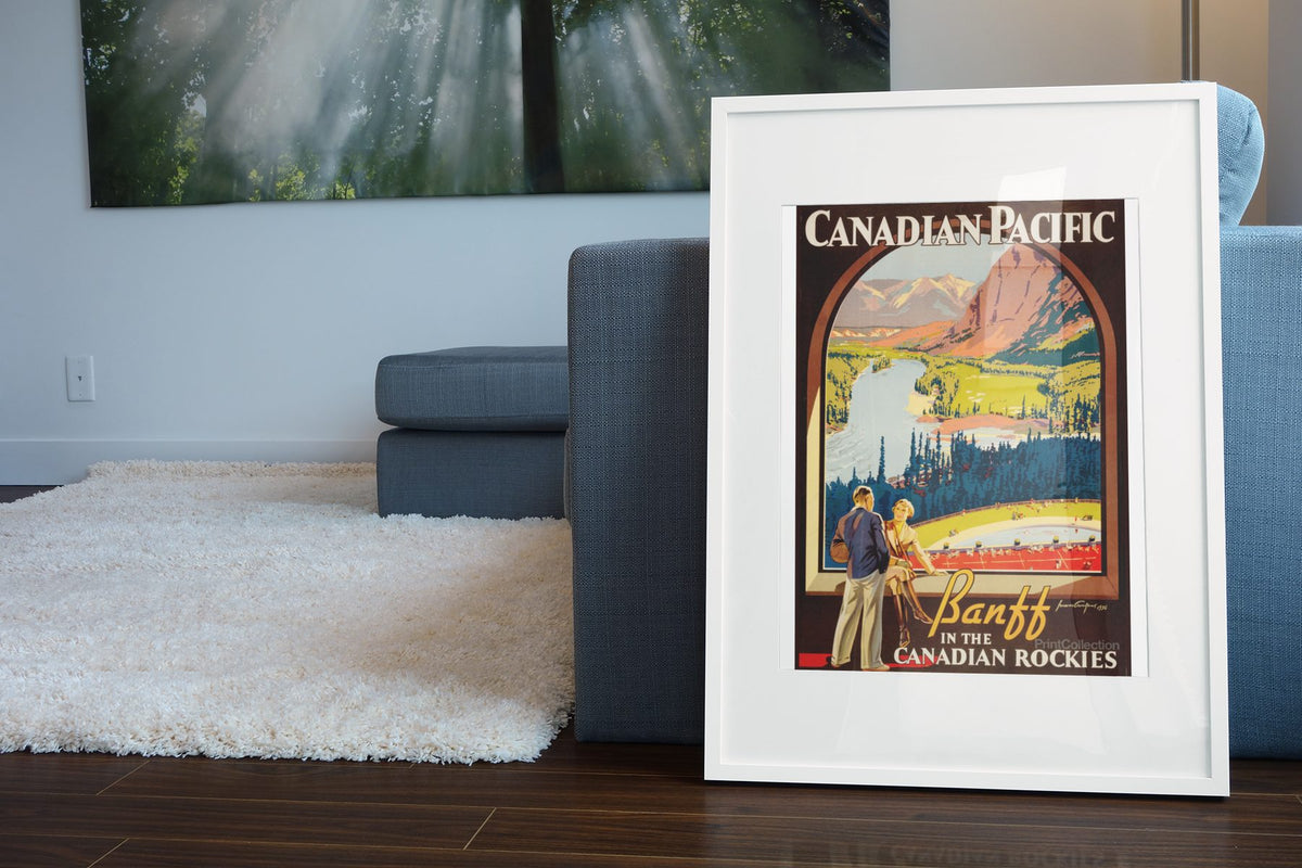 Banff Canadian Rockies poster leaning beside a blue sofa