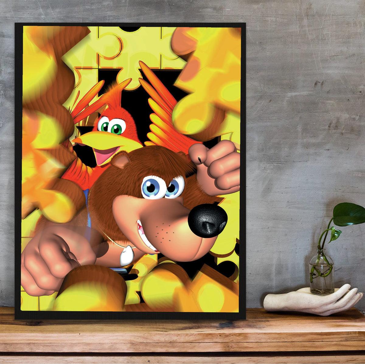 Banjo-Kazooie Magazine Cover Art poster in a black frame on a wooden shelf against concrete