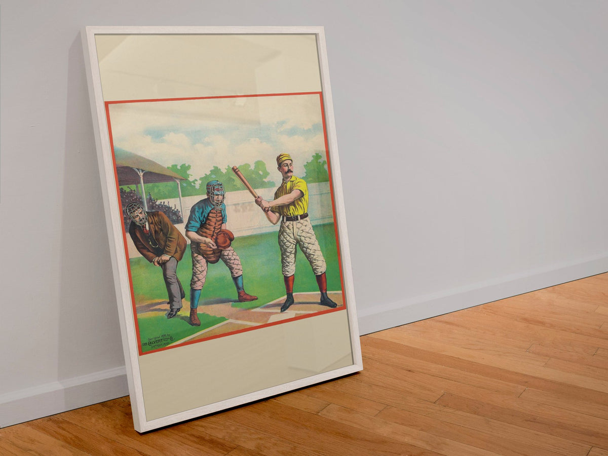 Baseball Batter 1895 poster in a white frame leaning against a wall