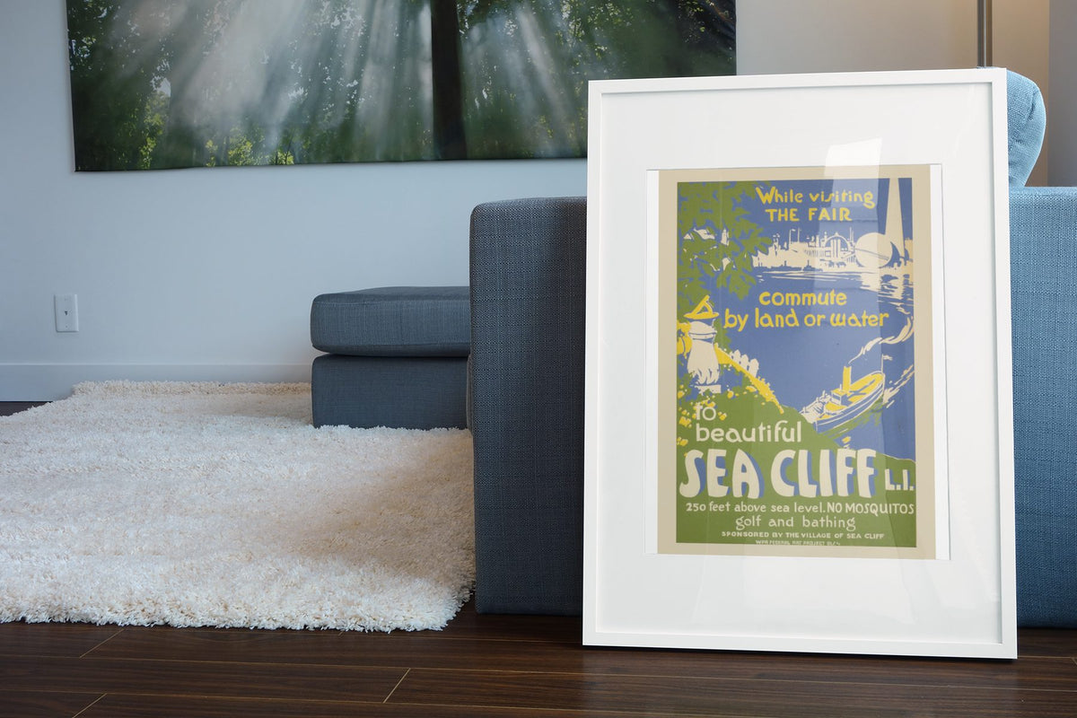 Beautiful Sea Cliff Long Island poster leaning beside a blue sofa