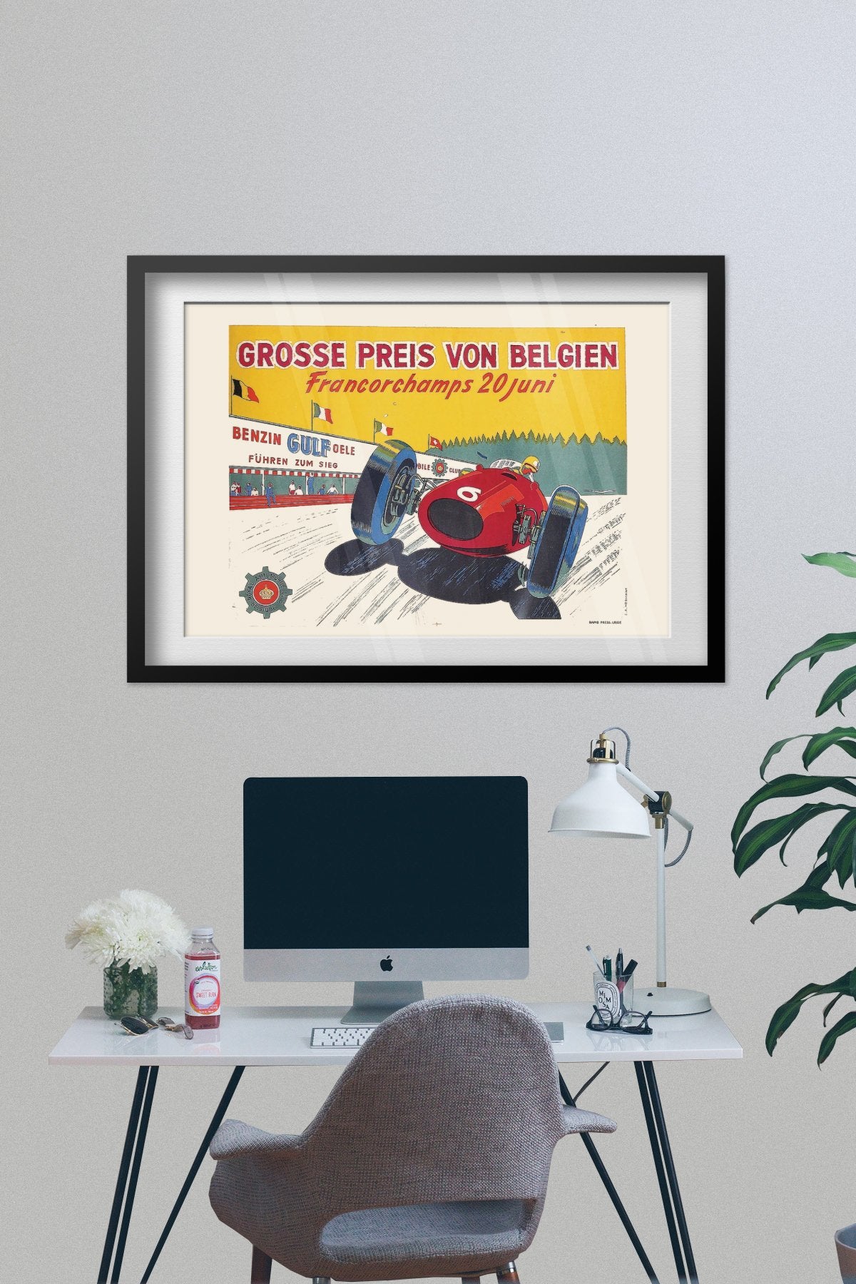 Belgian Grand Prix Francorchamps poster framed above a desk with a computer