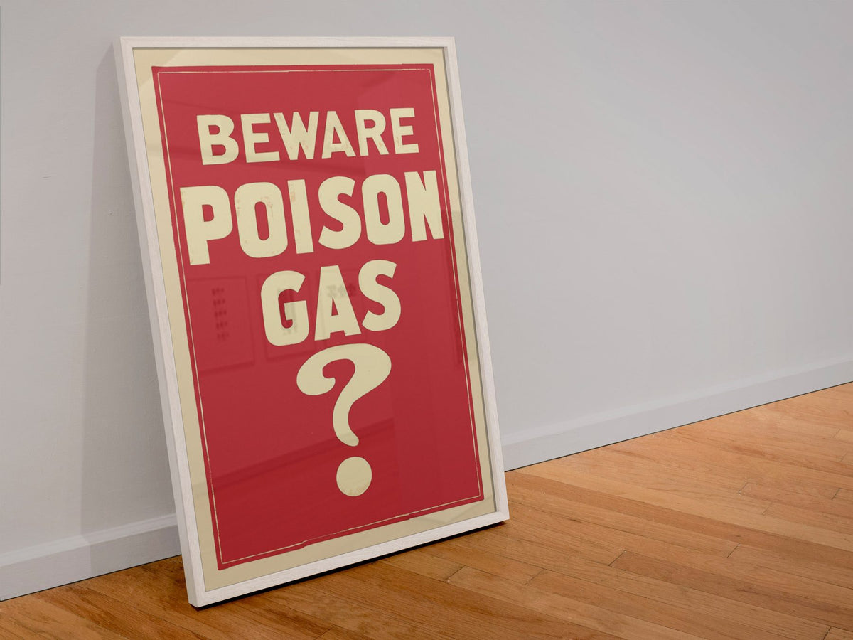 Beware Poison Gas poster in a white frame leaning against a wall