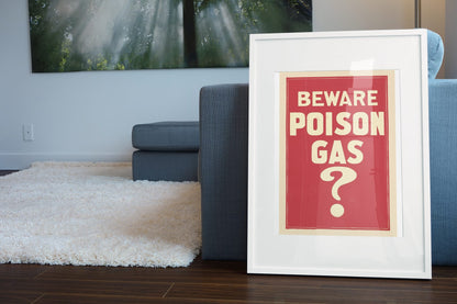 Beware Poison Gas poster leaning beside a blue sofa