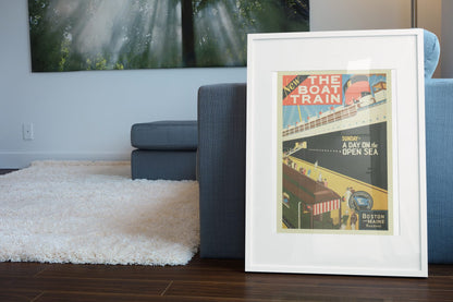 Boston and Maine Boat Train poster leaning beside a blue sofa