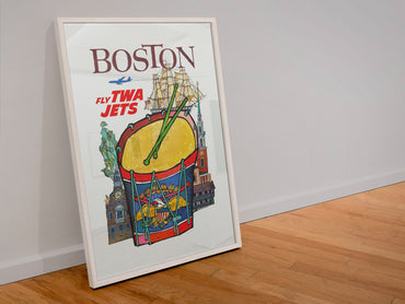 Boston Fly TWA Jets poster in a white frame leaning against a wall