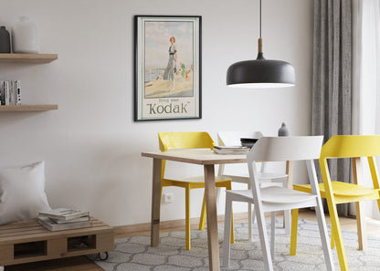 Bring Your Kodak 1925 poster framed above a dining table