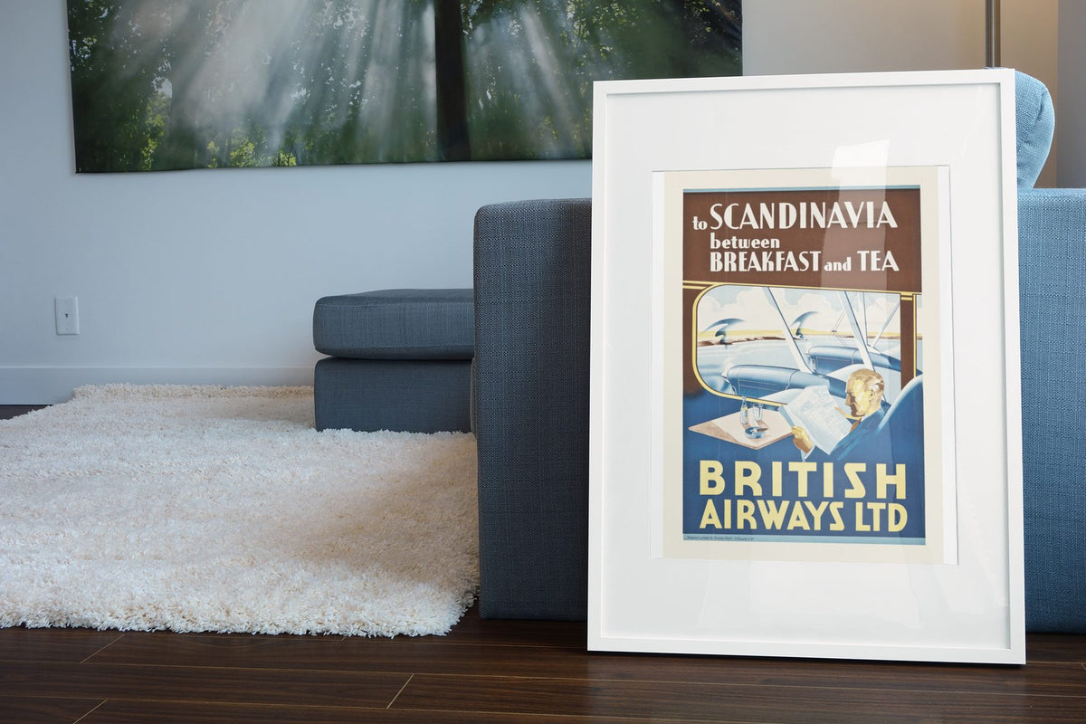 British Airways to Scandinavia poster leaning beside a blue sofa