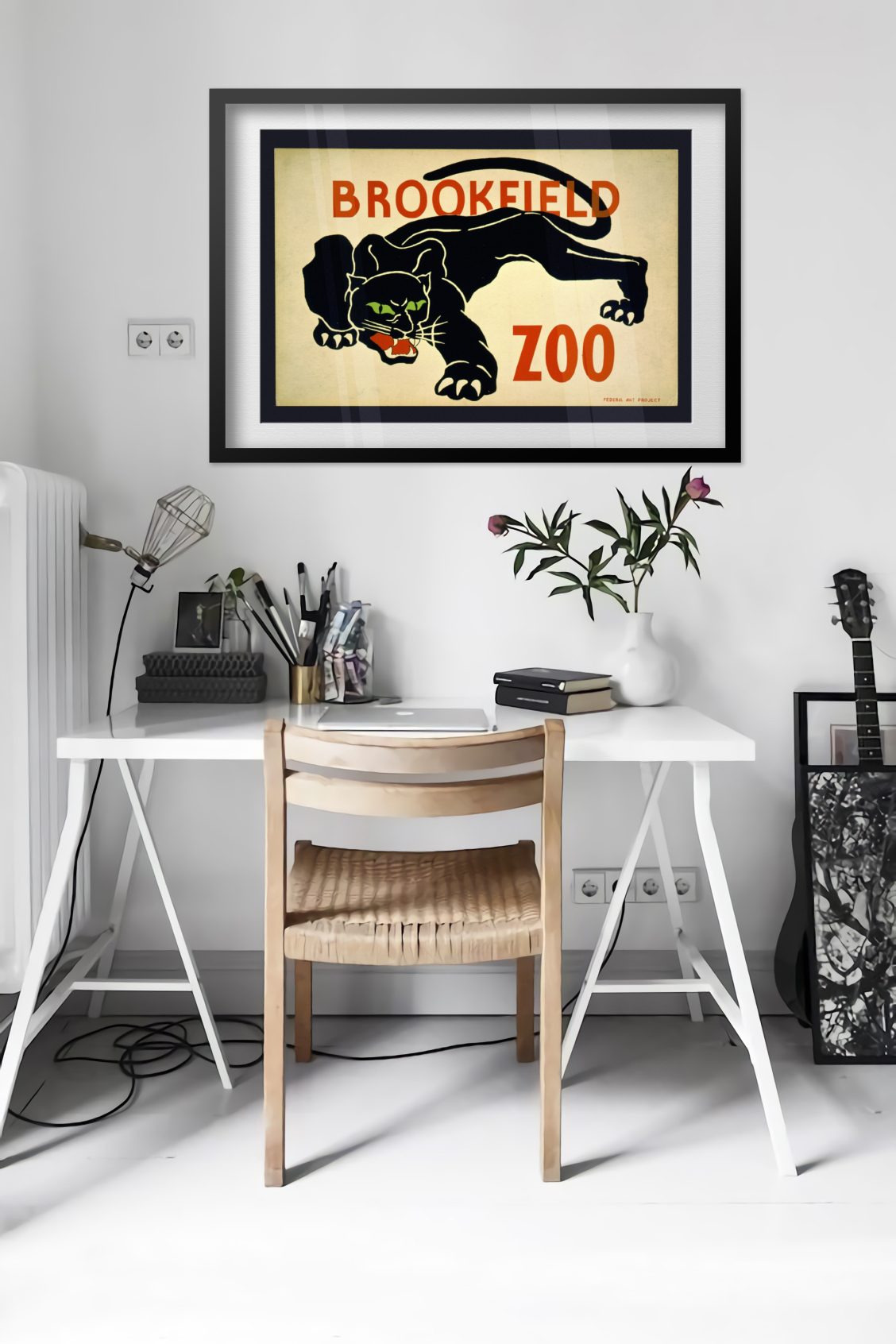 Brookfield Zoo Black Panther poster framed above a desk in a bright white room
