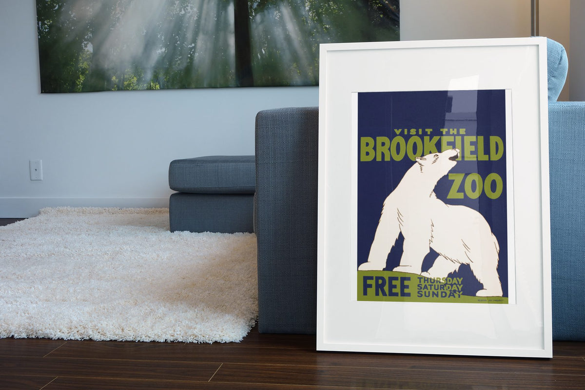 Brookfield Zoo Polar Bear poster leaning beside a blue sofa