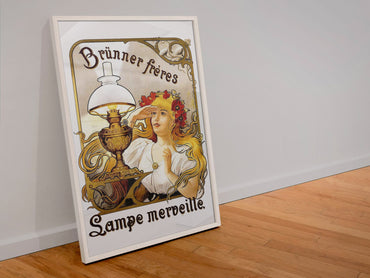 Brunner Freres Lamps poster in a white frame leaning against a wall