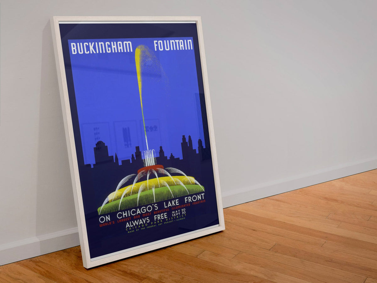 Buckingham Fountain Chicago poster in a white frame leaning against a wall