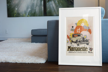 Buick Marquette poster in a white frame leaning beside a blue sofa
