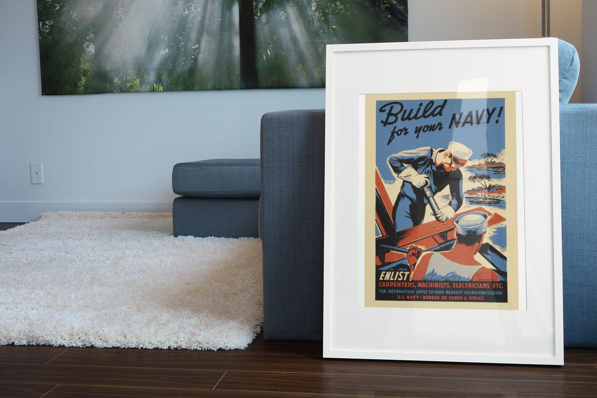 Build for Your Navy — Seabees poster leaning beside a blue sofa