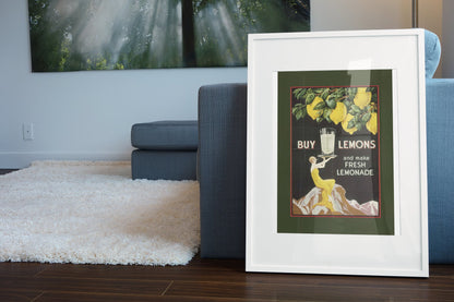 Buy Lemons 1920s lemonade poster in a white frame leaning beside a blue sofa